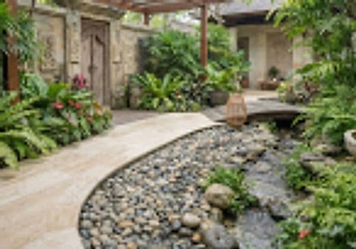 Biophilic sanctuary garden with pebble water stream and lush tropical foliage